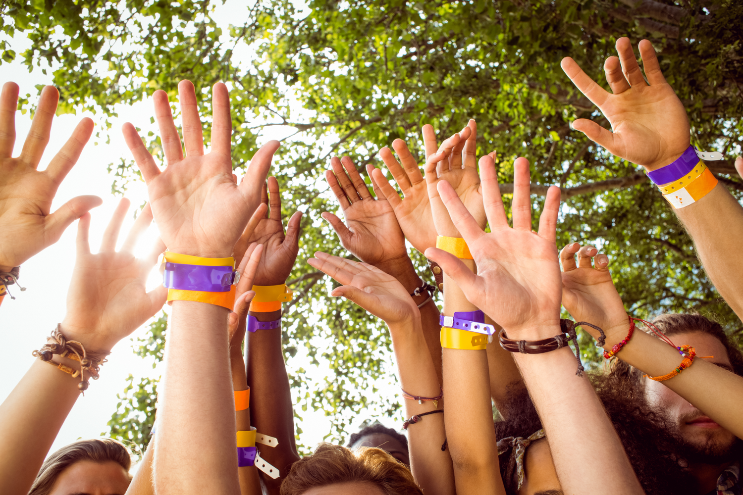 happy hipsters with hands up