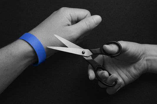 Paper wristband cut by scissors